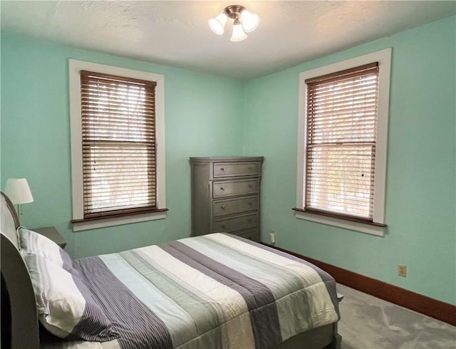 bedroom with baseboards and carpet flooring