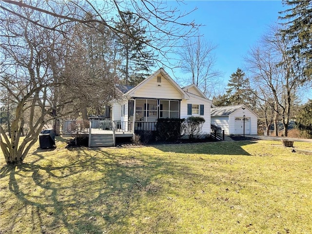 view of front of property with an outbuilding, a deck, a detached garage, a sunroom, and a front yard