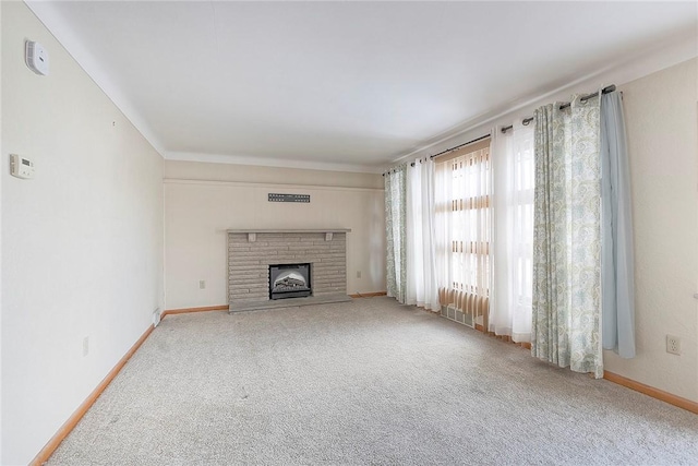 unfurnished living room featuring carpet, visible vents, a fireplace, and baseboards