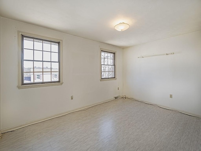 unfurnished room featuring light wood-type flooring