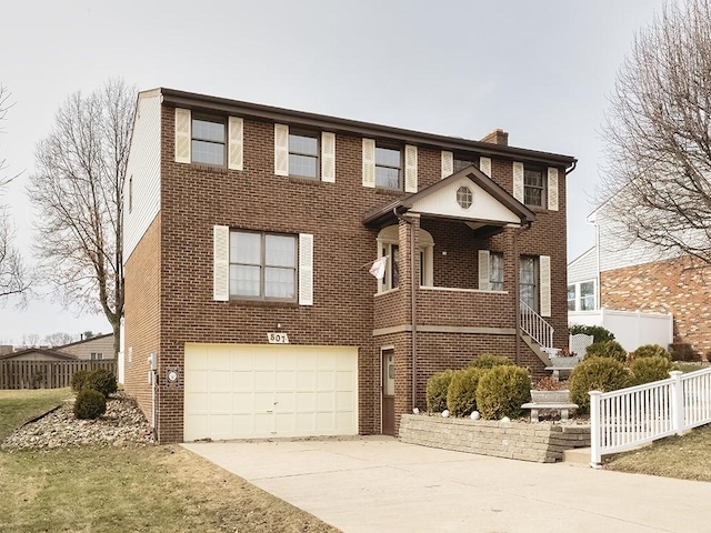 view of front of house with an attached garage, brick siding, fence, driveway, and a chimney