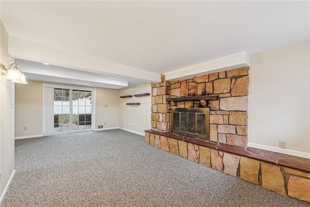 unfurnished living room with a fireplace, carpet flooring, visible vents, and baseboards