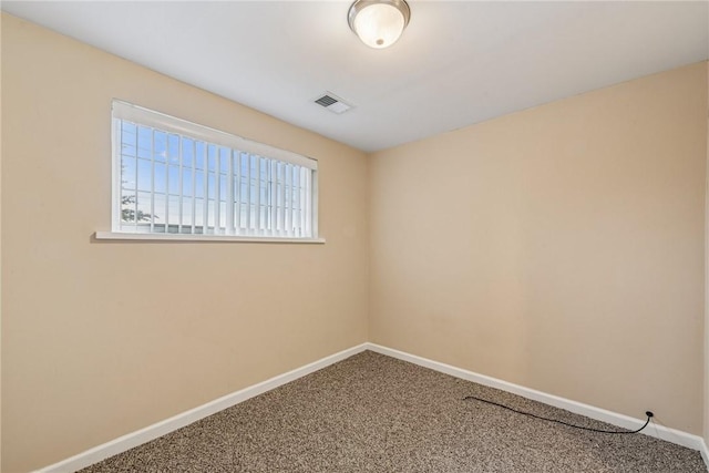 empty room with baseboards, visible vents, and carpet flooring