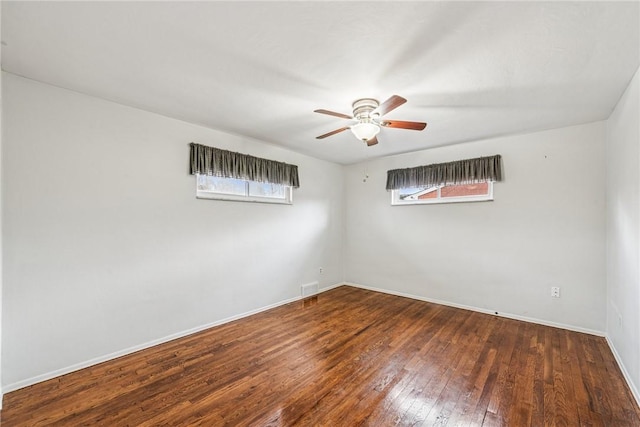 unfurnished room with a ceiling fan, visible vents, plenty of natural light, and hardwood / wood-style floors