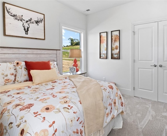 carpeted bedroom with a closet