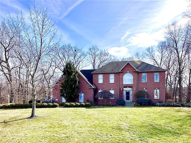 view of front facade with a front lawn and brick siding