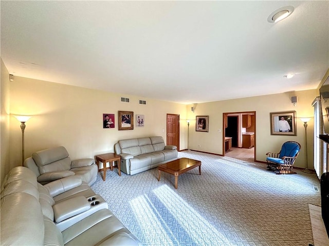 living room with light carpet, baseboards, and visible vents