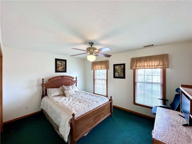 bedroom featuring carpet, visible vents, ceiling fan, a textured ceiling, and baseboards