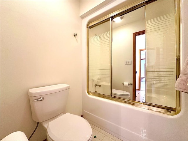 full bath featuring tile patterned flooring, toilet, and bath / shower combo with glass door