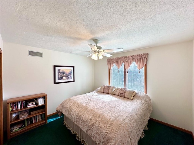 carpeted bedroom featuring visible vents, ceiling fan, a textured ceiling, and baseboards