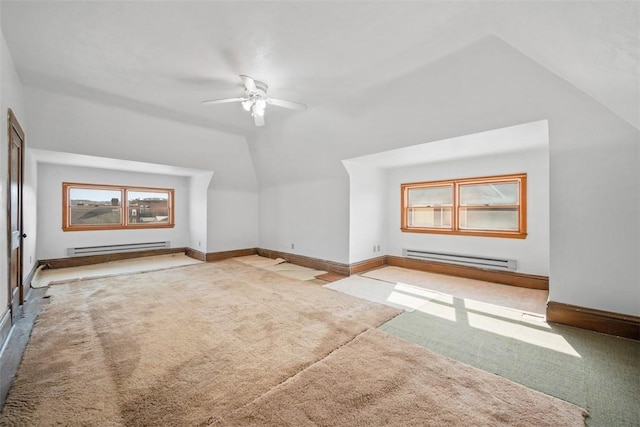 bonus room with a baseboard heating unit, baseboards, carpet flooring, and lofted ceiling