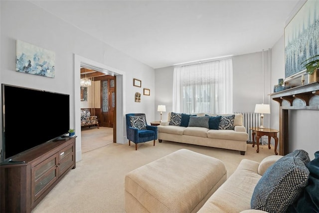 living area featuring light colored carpet and a notable chandelier