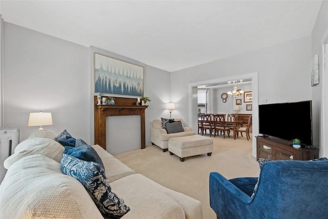 carpeted living area featuring a notable chandelier