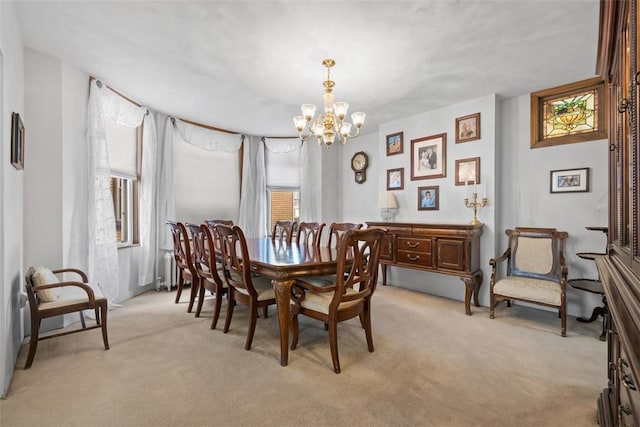 dining room with a chandelier and light carpet