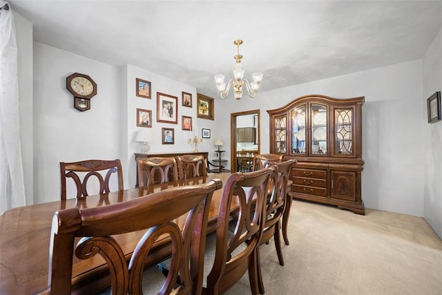 dining area featuring light carpet and an inviting chandelier