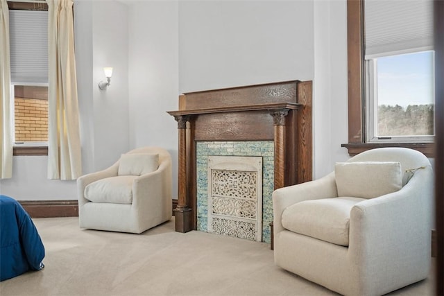 living area with carpet and a fireplace