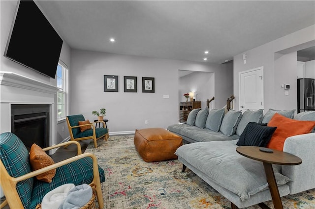 living room featuring recessed lighting, a fireplace, and baseboards