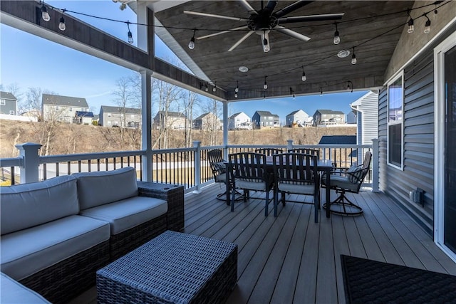 wooden deck with outdoor dining area, a residential view, an outdoor living space, and a ceiling fan