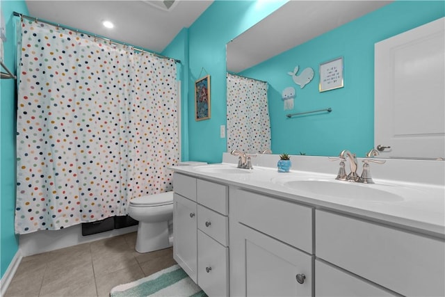 full bath with double vanity, tile patterned flooring, a sink, and toilet