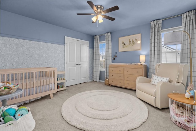 bedroom with carpet floors, a closet, and a ceiling fan