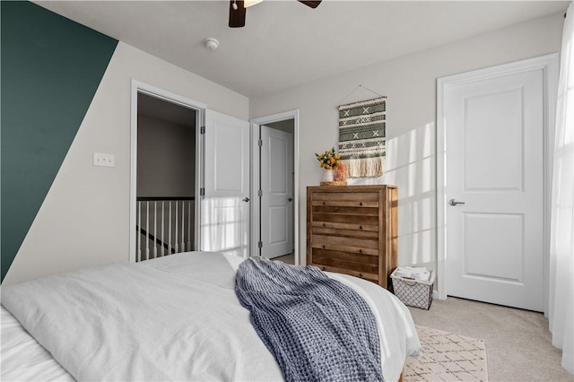 bedroom featuring light carpet and a ceiling fan