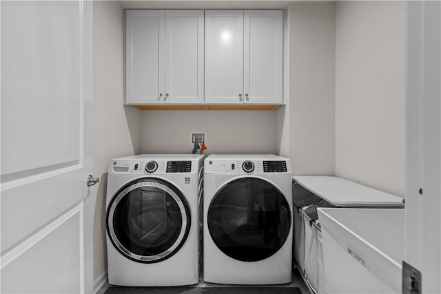 laundry area with cabinet space and washing machine and clothes dryer