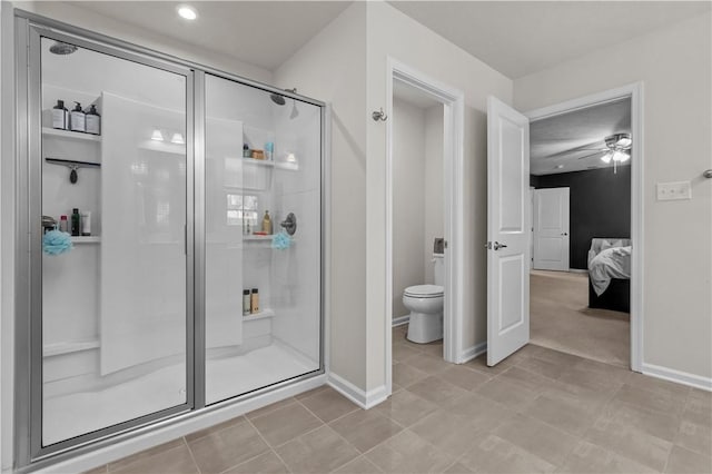 ensuite bathroom featuring toilet, a shower stall, baseboards, and connected bathroom