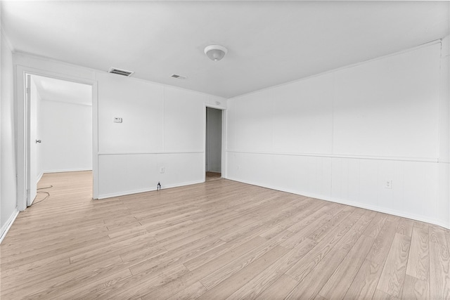 empty room with visible vents and light wood-style floors