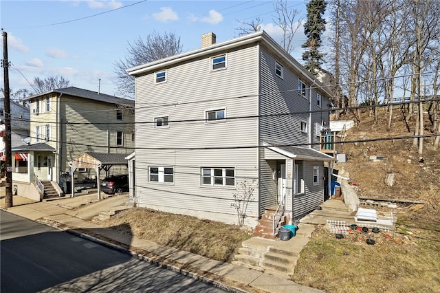 back of property featuring a chimney