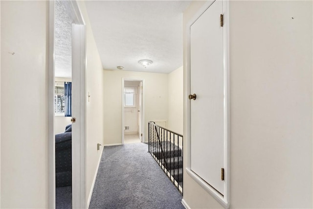 corridor with carpet and baseboards