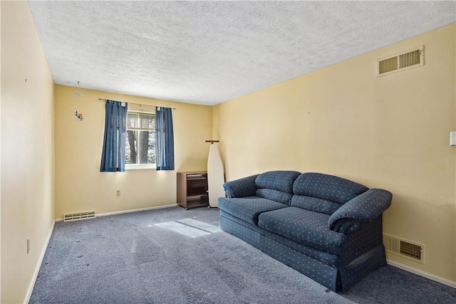 carpeted living area featuring visible vents and baseboards