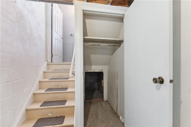 stairway with concrete floors and concrete block wall