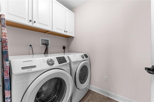 washroom with washer and dryer, tile patterned flooring, cabinet space, and baseboards