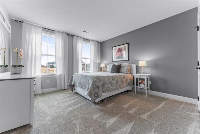 bedroom featuring carpet flooring, visible vents, and baseboards