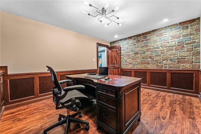 office area featuring dark wood-style floors and a wainscoted wall