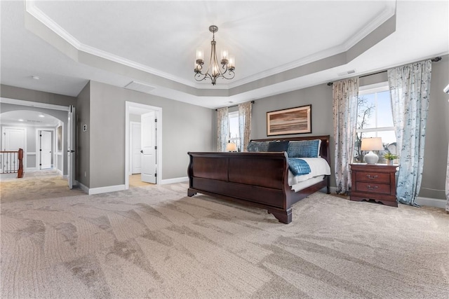 bedroom featuring a chandelier, arched walkways, a raised ceiling, and carpet