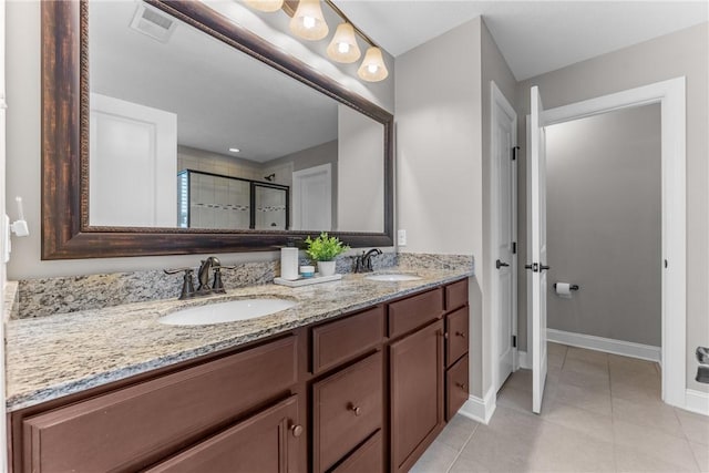 full bath with visible vents, a sink, a shower stall, and double vanity