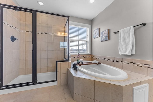 bathroom with a stall shower, a garden tub, recessed lighting, and tile patterned floors