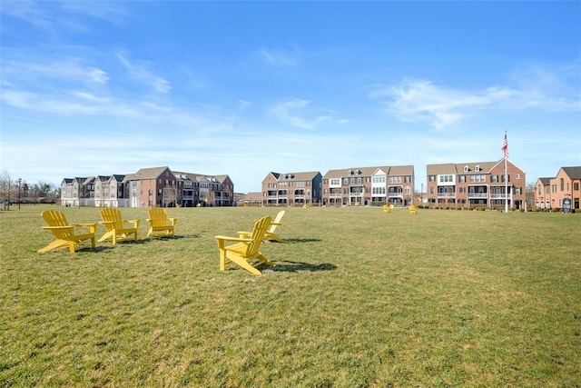 exterior space with a residential view and a lawn