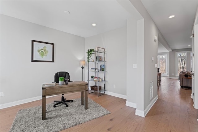 office featuring light wood-type flooring, baseboards, and recessed lighting