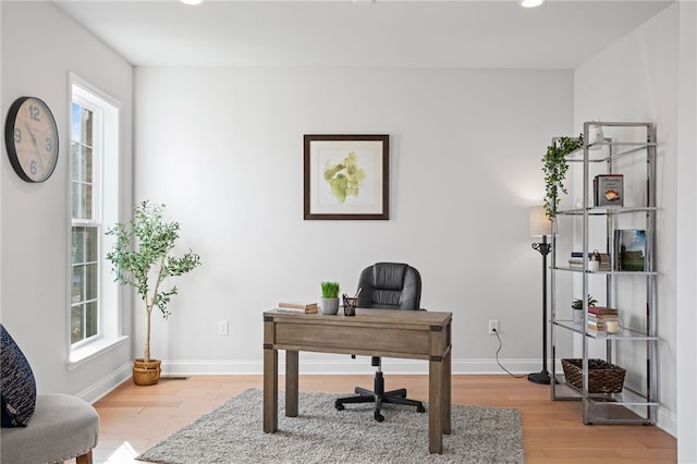 office featuring baseboards and wood finished floors