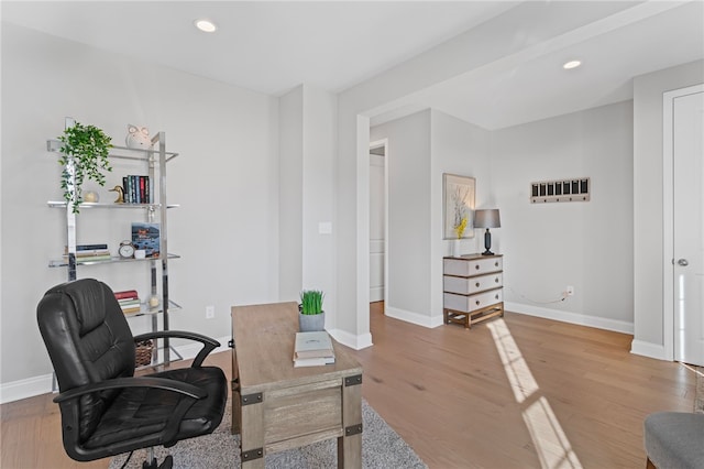 office space featuring baseboards, wood finished floors, and recessed lighting