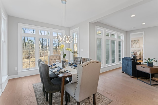 dining area with baseboards, light wood finished floors, and recessed lighting