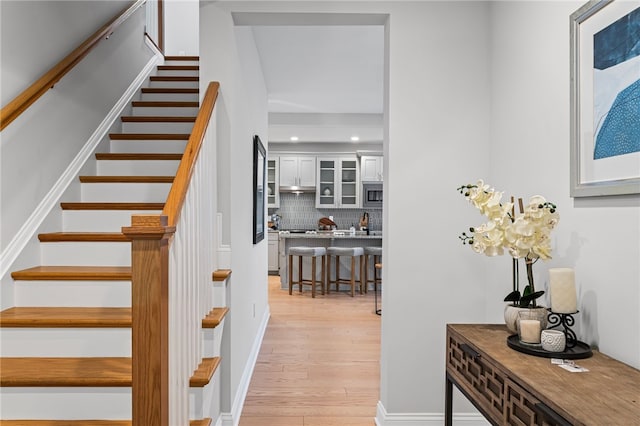 stairs featuring recessed lighting, baseboards, and wood finished floors