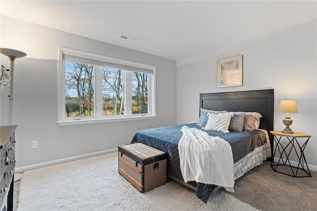 bedroom featuring carpet, visible vents, and baseboards