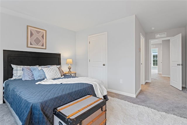 bedroom featuring light carpet, visible vents, and baseboards