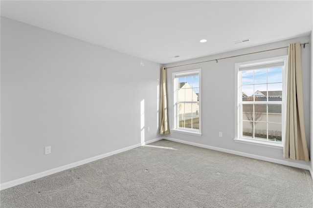 spare room featuring carpet, baseboards, visible vents, and recessed lighting