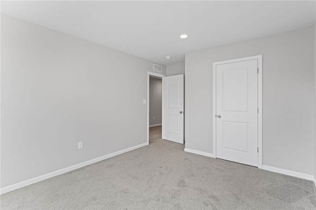 unfurnished bedroom featuring carpet, visible vents, baseboards, and recessed lighting