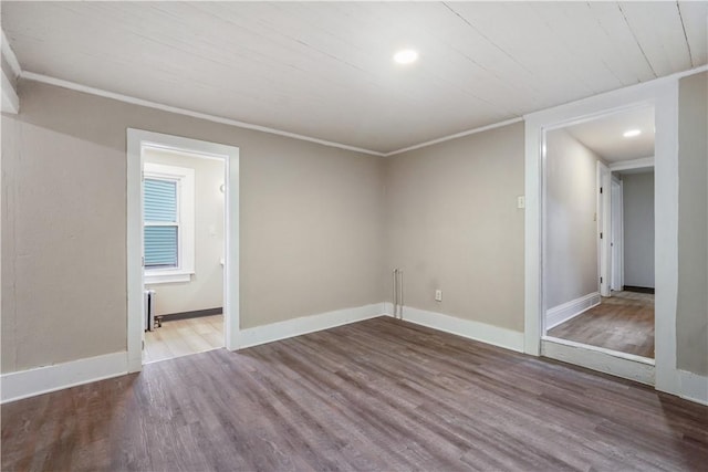 unfurnished room featuring crown molding, baseboards, wood finished floors, and recessed lighting