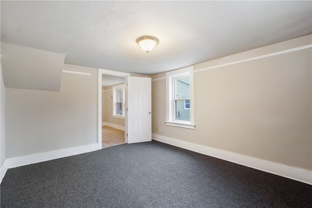 unfurnished bedroom featuring baseboards and carpet flooring